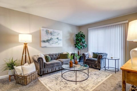 a living room with couches and chairs and a table